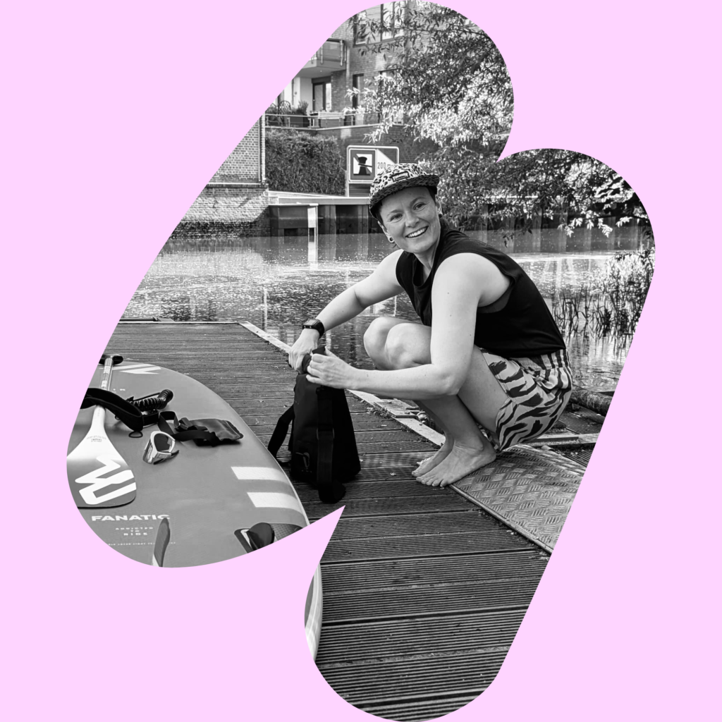 SUP instructor and yoga teacher Nele Sienknecht at the harbour of Buxtehude ready to go on a SUP tour Altes Land